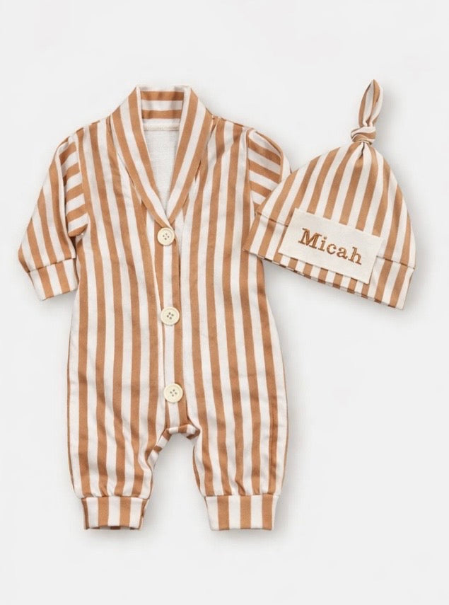 Baby romper with striped pattern and matching hat on a white background