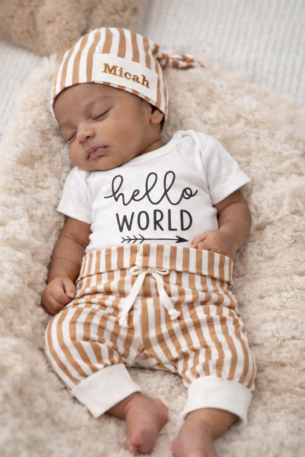 Complete 4-piece stripe baby gift set with custom embroidered name hat. The ultimate personalized newborn gift, soft, neutral, and beautifully packaged. From $64.99.