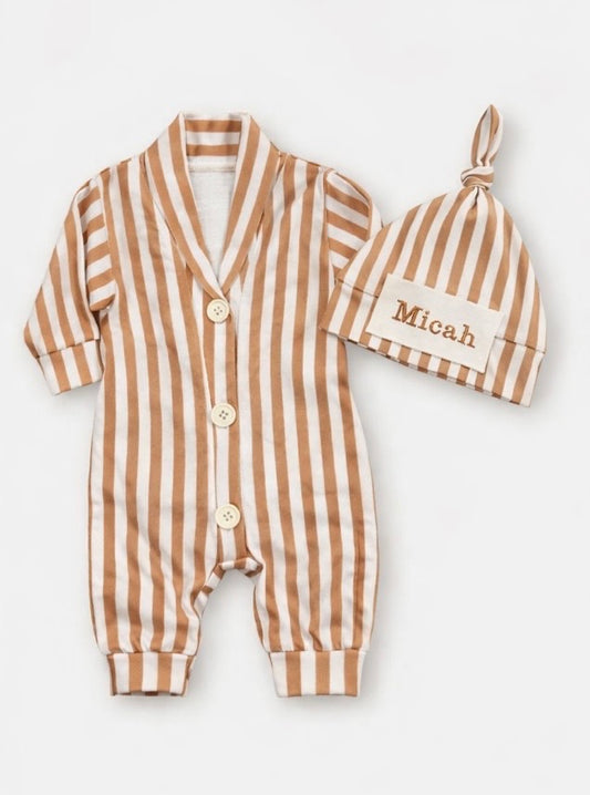 Baby romper with striped pattern and matching hat on a white background